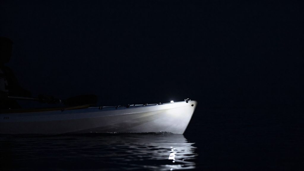 When must a canoe or kayak show a white light?